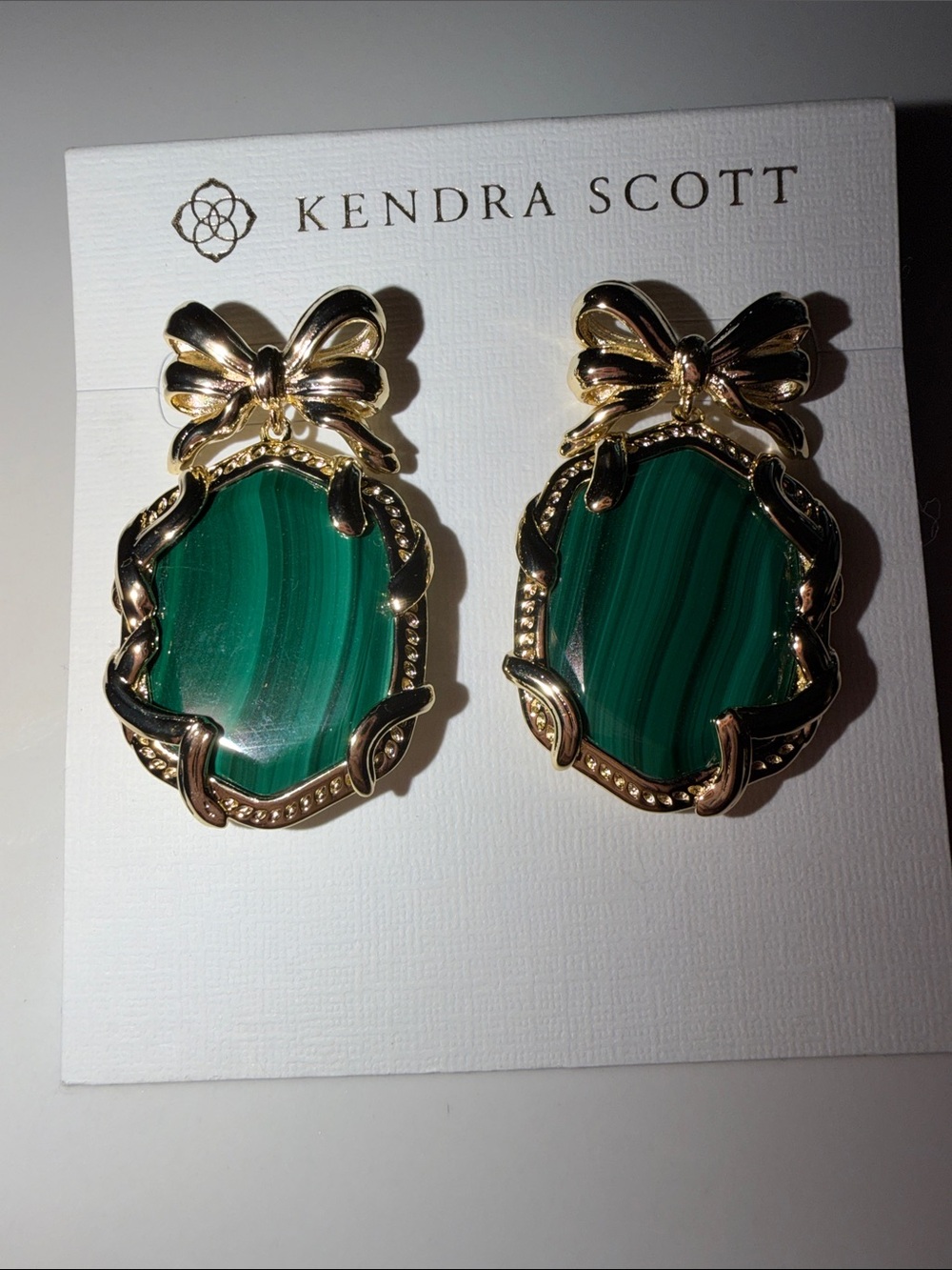 Kendra Scott Gold Bow Earrings with Emerald-Green Stones